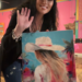 Tiffany Bohrer holding her original Coastal Cowgirl painting